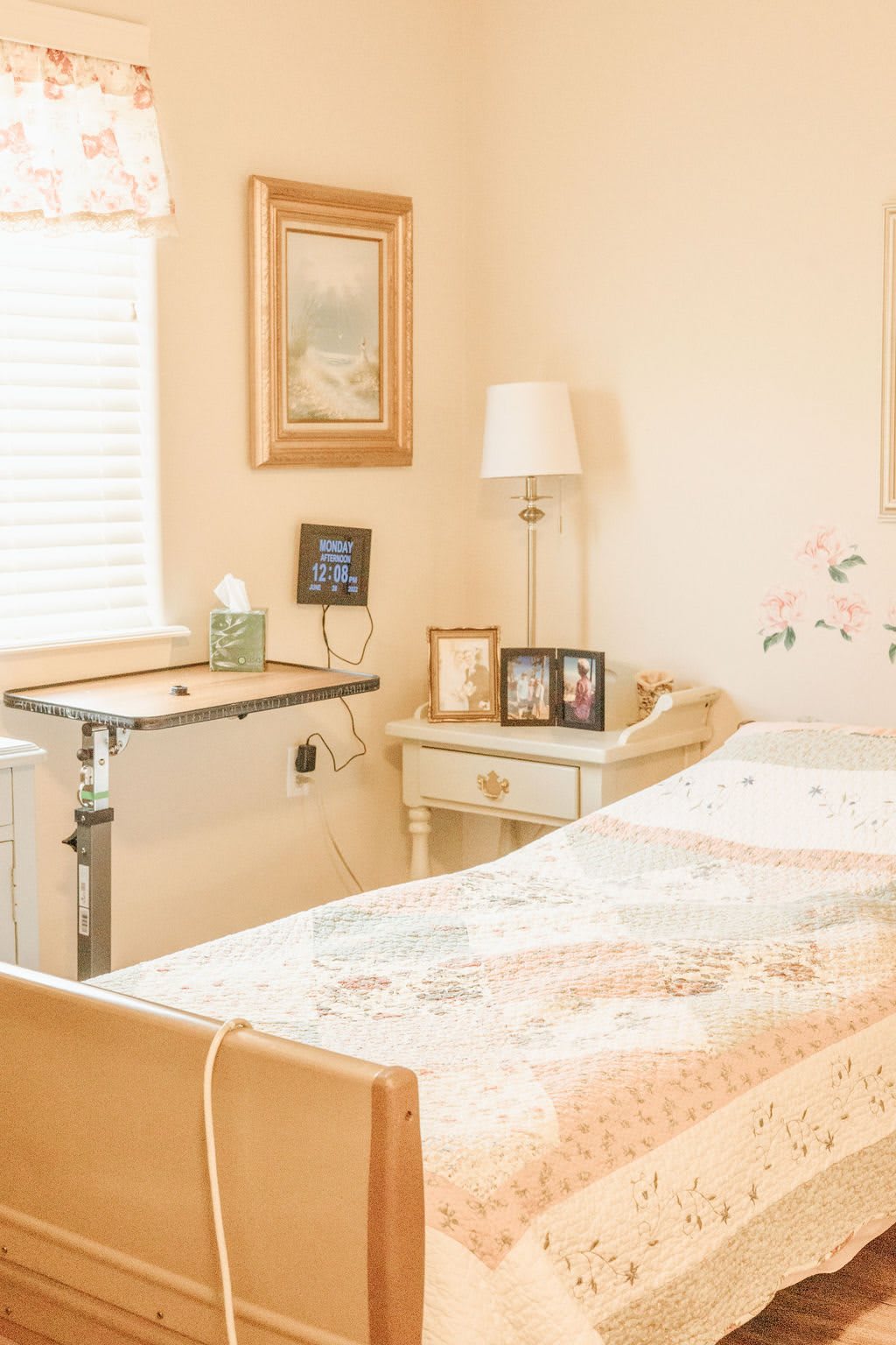 A cozy bedroom with a hospital bed, featuring decorative elements and soft lighting.