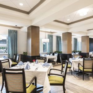A modern restaurant interior with neatly arranged tables and chairs.