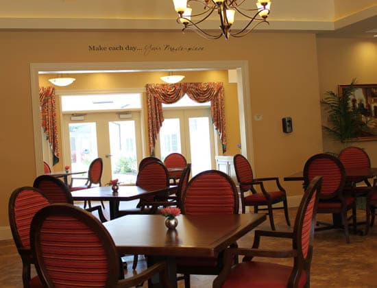 A well-furnished dining room with elegant chairs, tables, and a chandelier.