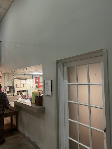 A glimpse of a restaurant interior showcasing the counter and an adjacent door.