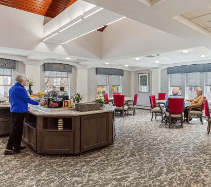 A spacious and well-lit lobby with a reception desk and seating area.