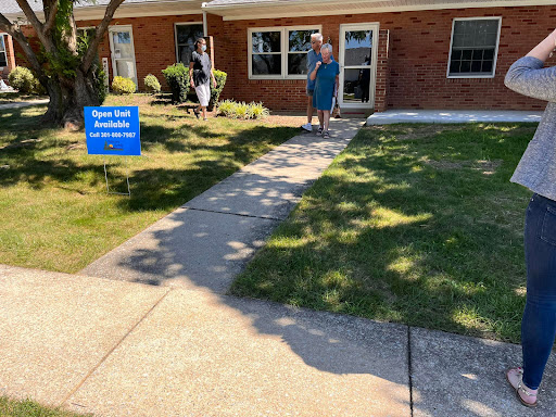 A sunny day at a real estate open house with visitors exploring the property.