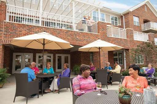 Residents enjoying a sunny day outdoors at a community gathering place.