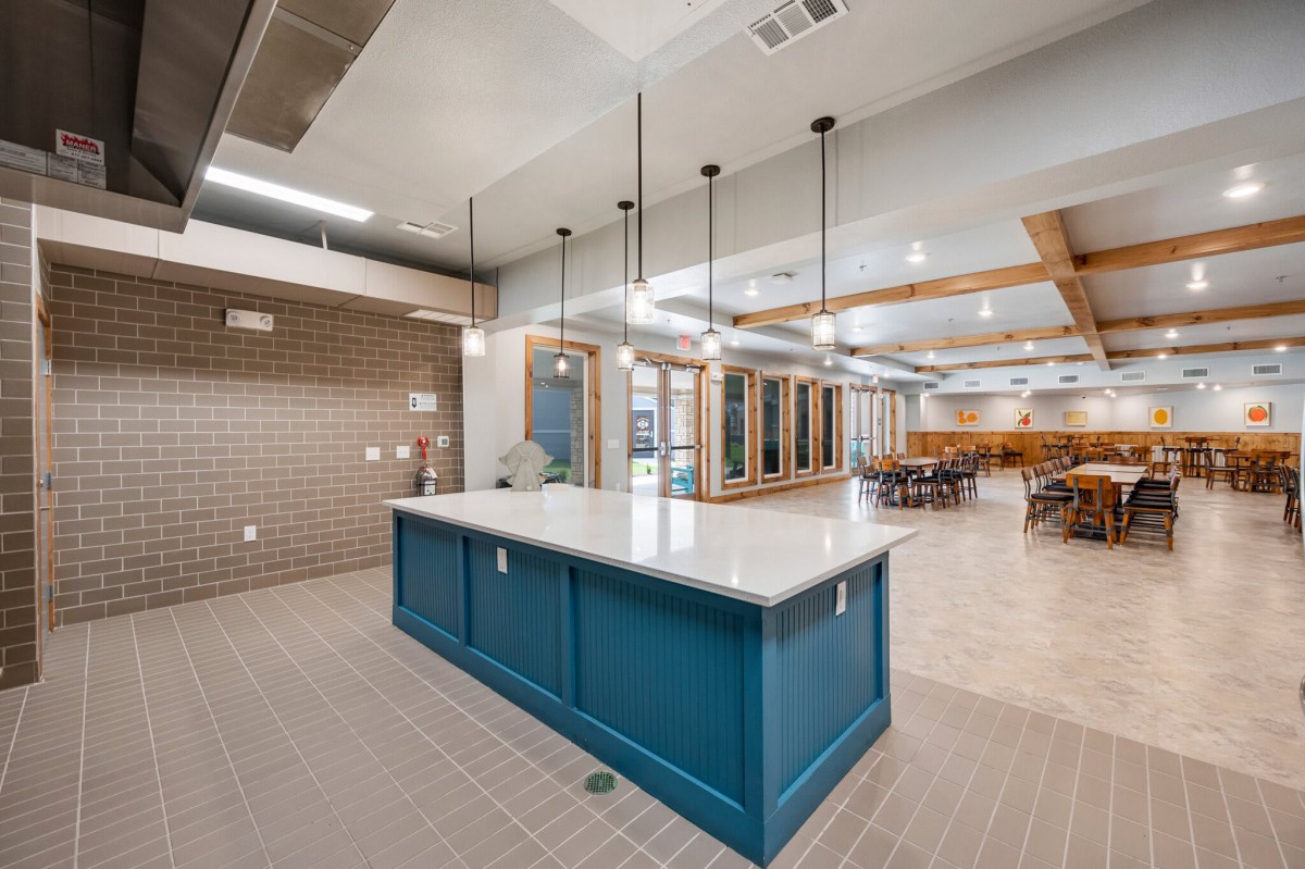 A modern kitchen interior featuring a central island with pendant lighting and contemporary design elements.