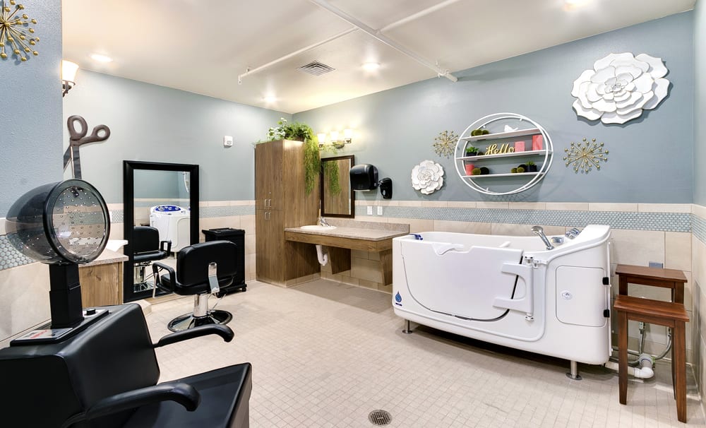 A modern beauty salon interior featuring a hairdressing station and a specialized bathtub.
