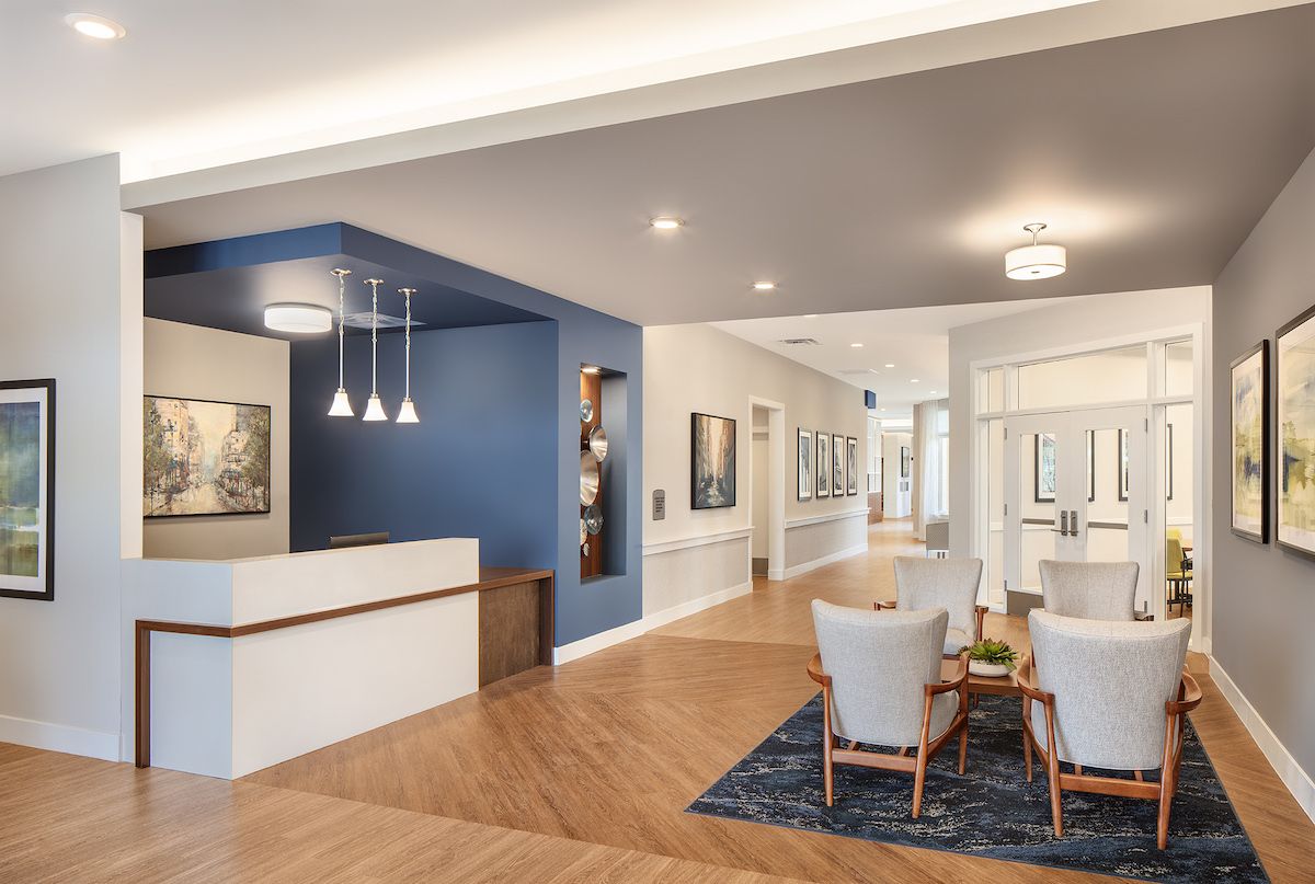 A modern reception area featuring comfortable seating and elegant lighting.