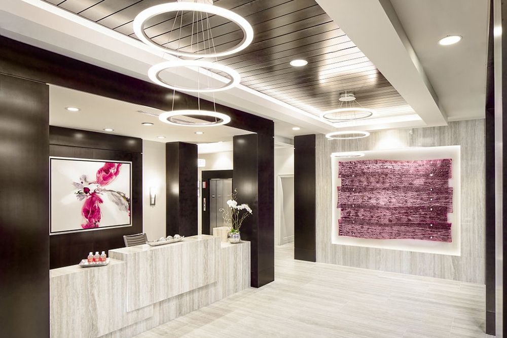 A modern reception area featuring contemporary art and elegant lighting fixtures.