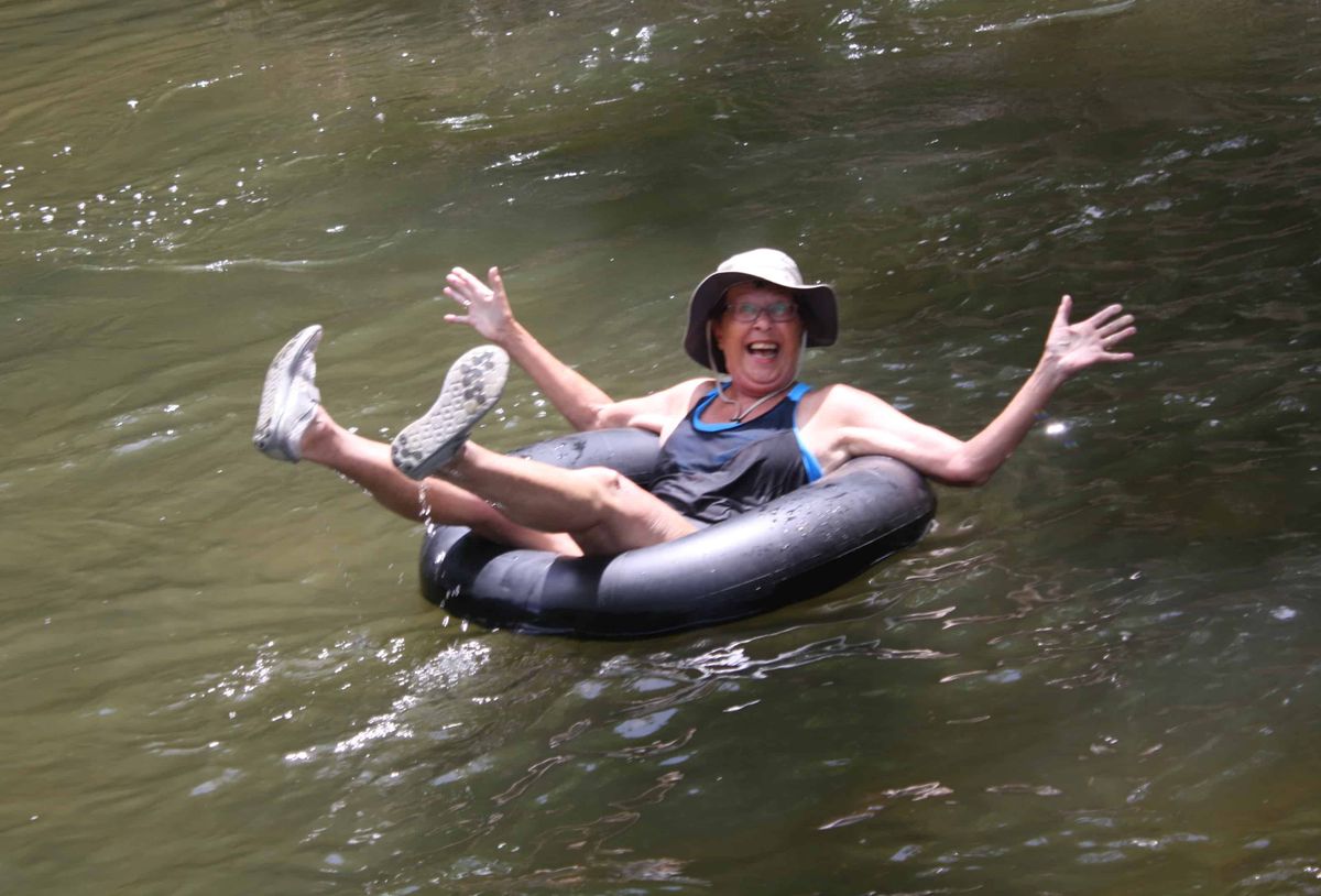 A person enjoying a relaxing float down the river in an inner tube.