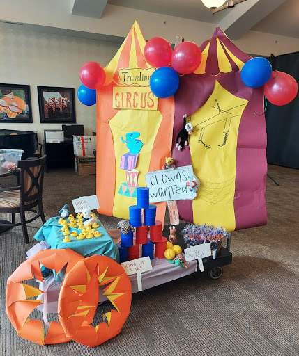 A vibrant circus-themed play area decorated with balloons and colorful tents, perfect for children's entertainment.