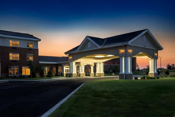 An illuminated hotel entrance at dusk.