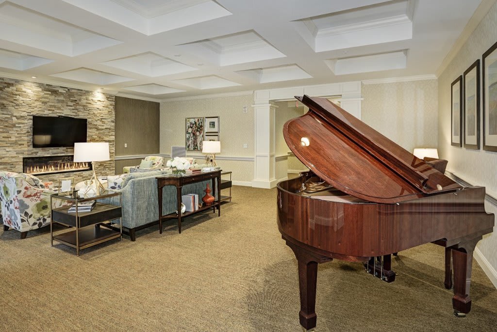A luxurious living room featuring a grand piano and elegant furnishings.