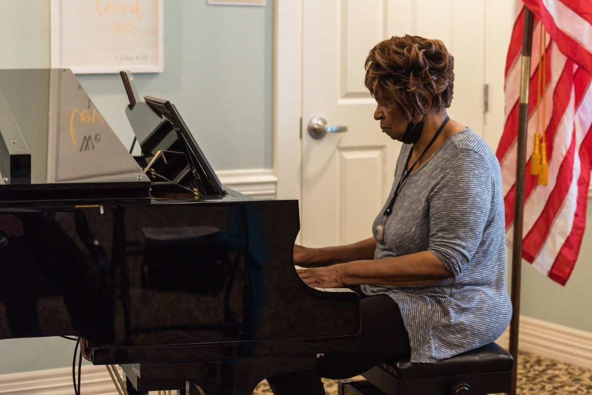 A woman playing the piano indoors.