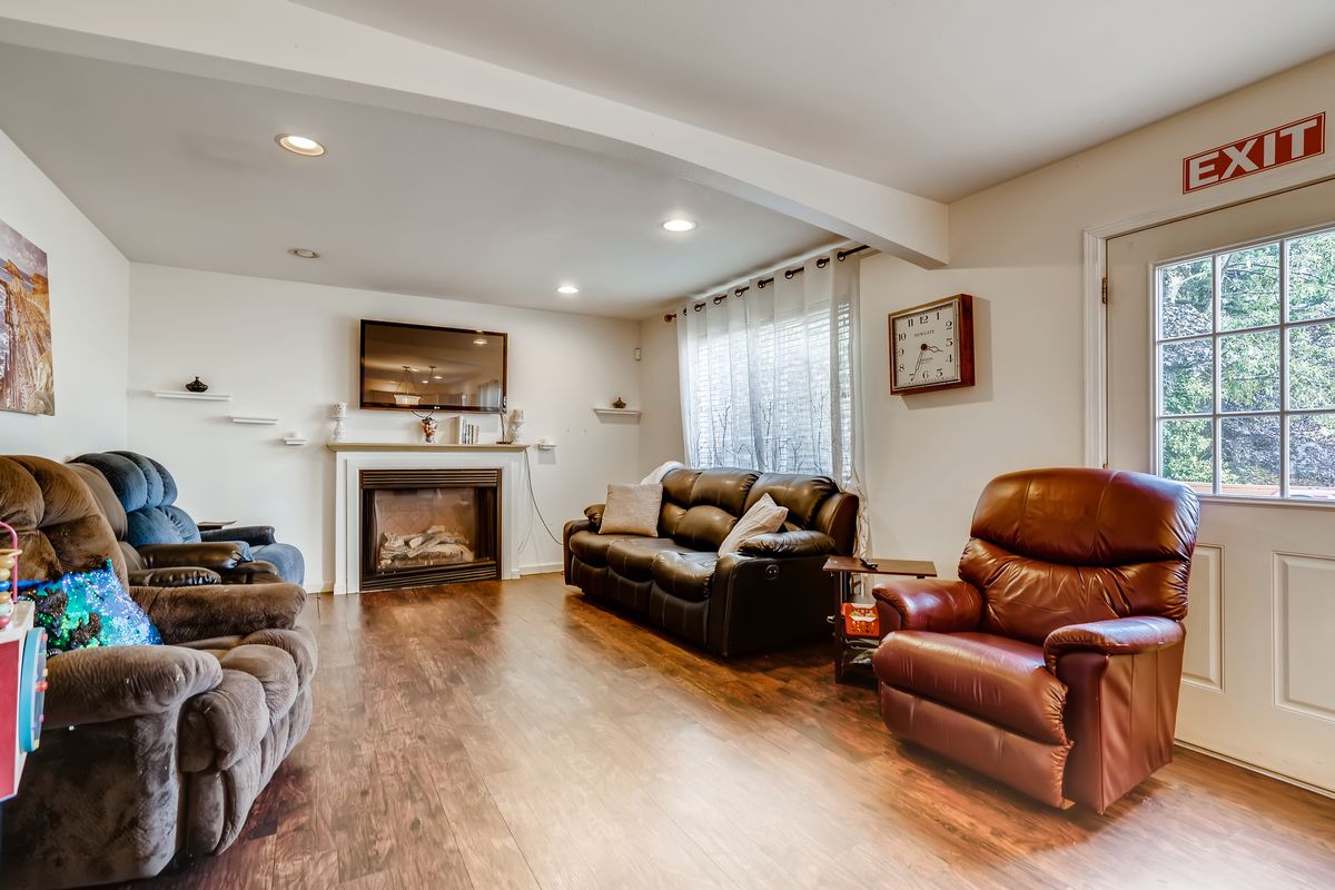 A cozy living room with comfortable seating and a fireplace.