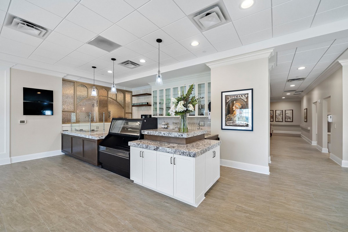 A modern kitchen interior featuring an island counter and pendant lighting.
