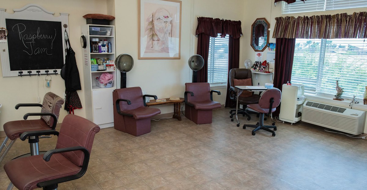 A cozy salon interior featuring hair dryers and a nail station.