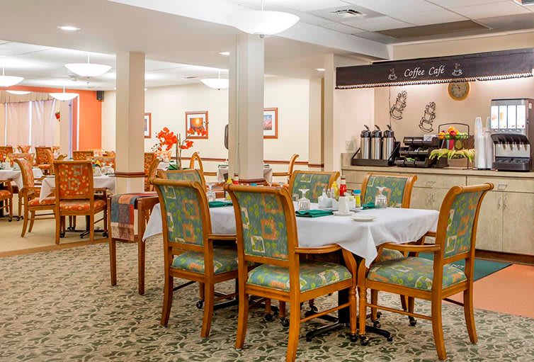 An elegant dining area with neatly arranged tables and chairs.