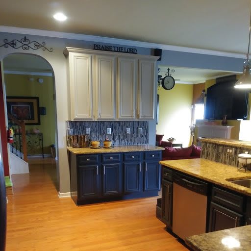 A modern kitchen with wooden floors, sleek countertops, and stylish cabinets.