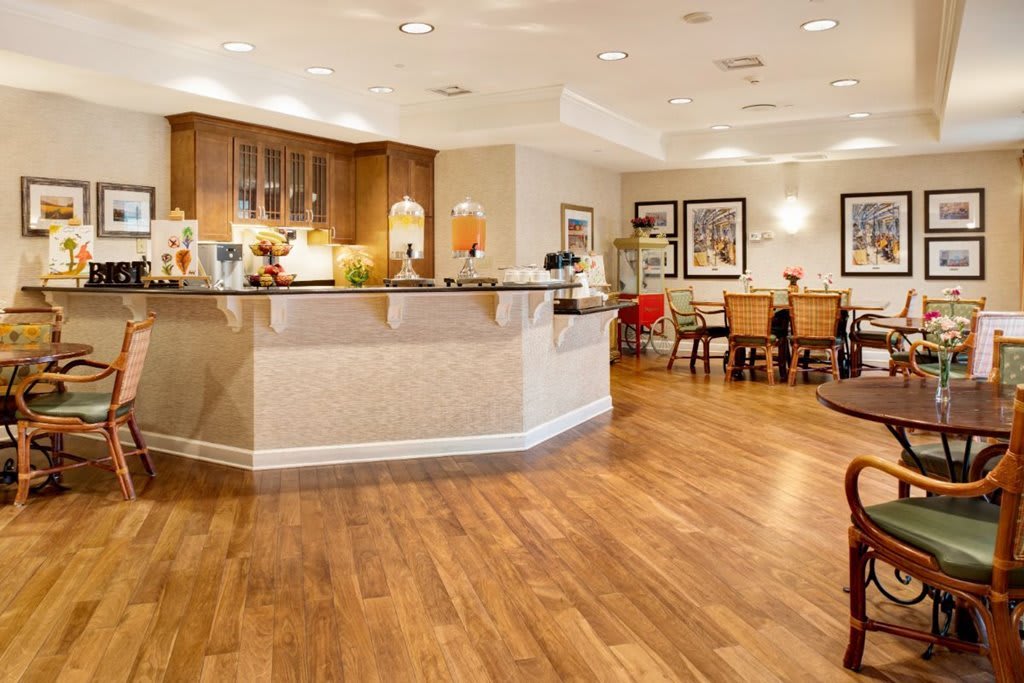 A modern kitchen and dining area with wooden flooring and stylish decor.