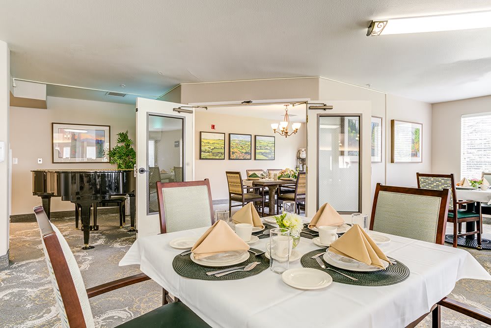 A well-arranged dining area with elegant table settings and bright decor.