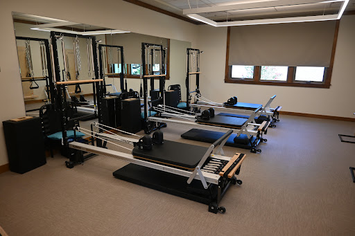 A serene Pilates studio equipped with multiple reformers for fitness training.