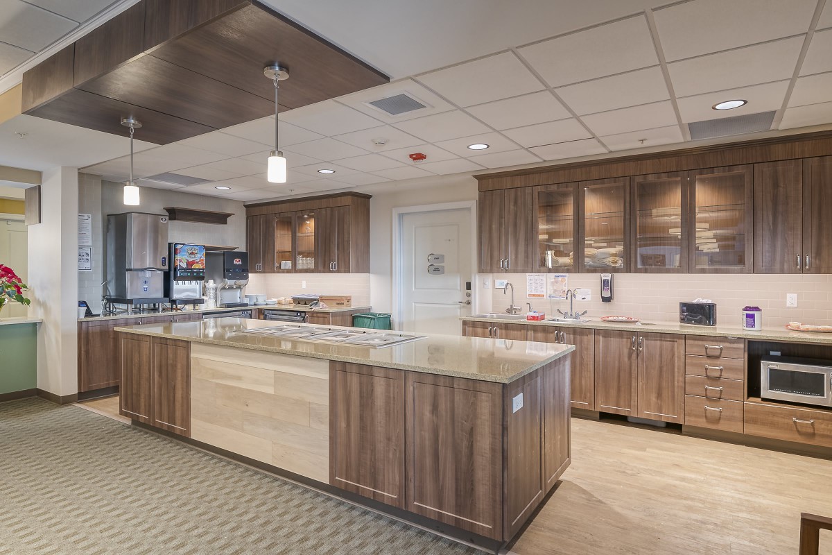 A spacious modern kitchen with wooden cabinets and a large central island.
