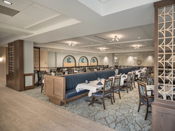 An elegant restaurant dining area with neatly arranged tables and chairs.