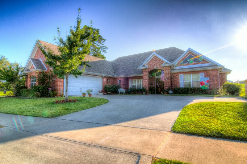 A suburban house with a well-maintained front yard and driveway.