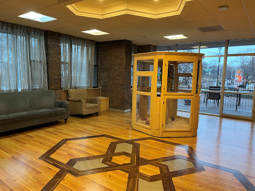 A well-designed lobby featuring a wooden structure, comfortable seating, and elegant flooring.