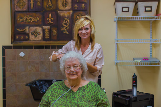 A hairstylist giving a stylish new look to an elderly woman in a warm and inviting salon.