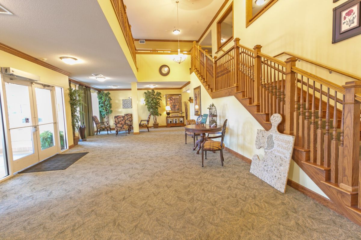 A spacious lobby with a staircase and comfortable seating area.