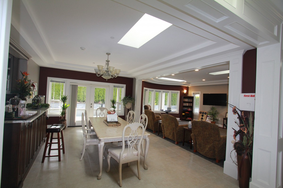 A modern open-plan living and dining area with elegant furniture and abundant natural light.