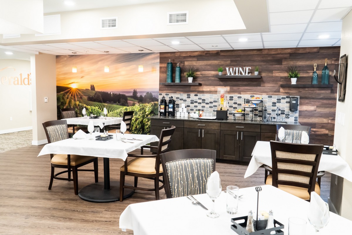 An elegantly designed restaurant interior with a wine-themed decor and neatly set tables.