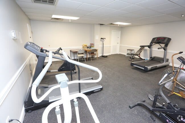 A fitness room equipped with treadmills and other exercise machines.