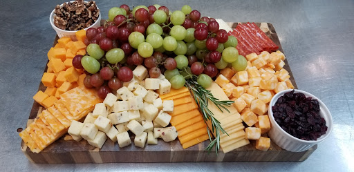 A delightful assortment of cheeses and fresh grapes arranged on a platter, perfect for gatherings.