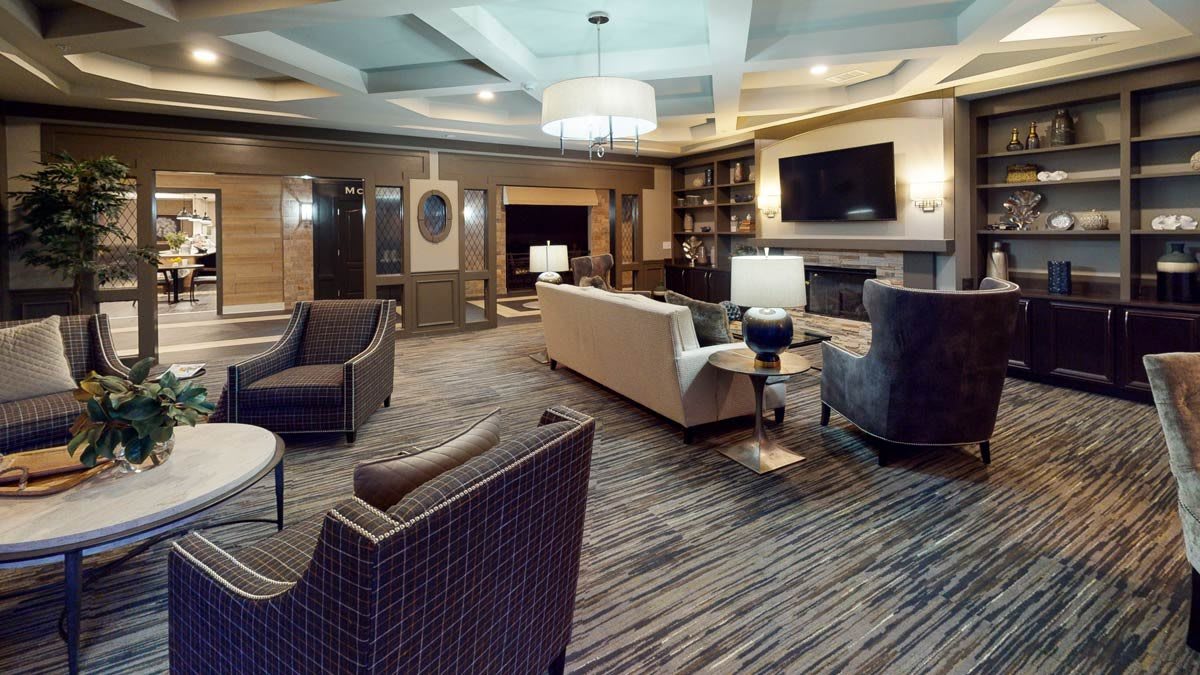 A modern, well-lit living room with comfortable seating and elegant furnishings.