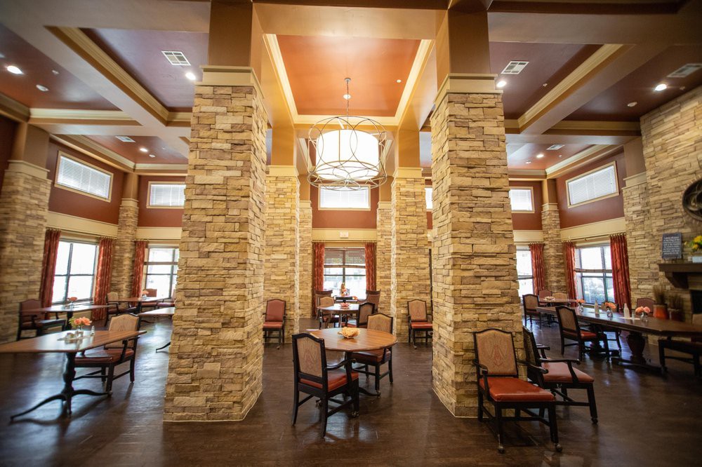 Elegant dining area with stone pillars and warm lighting.