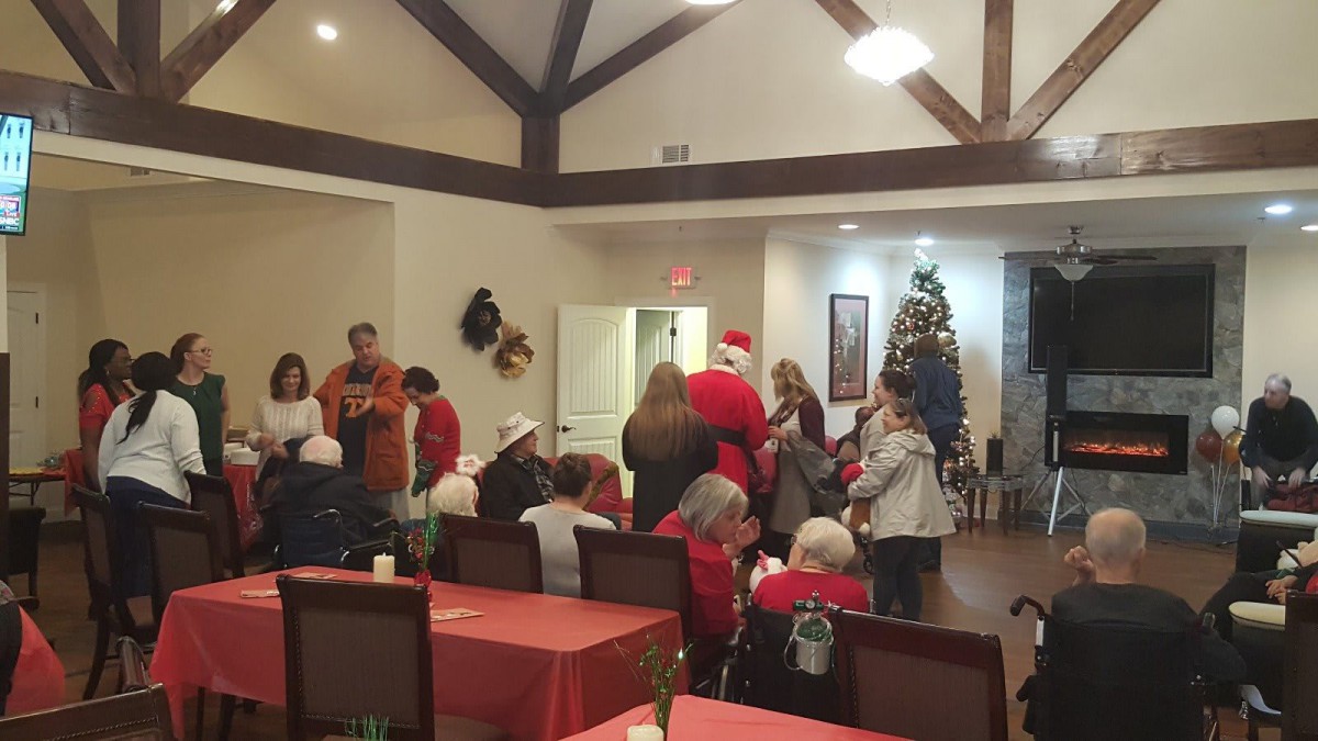 A festive Christmas gathering with Santa Claus and holiday decorations.