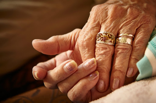 A tender moment of connection between two elderly hands, showcasing love and togetherness.