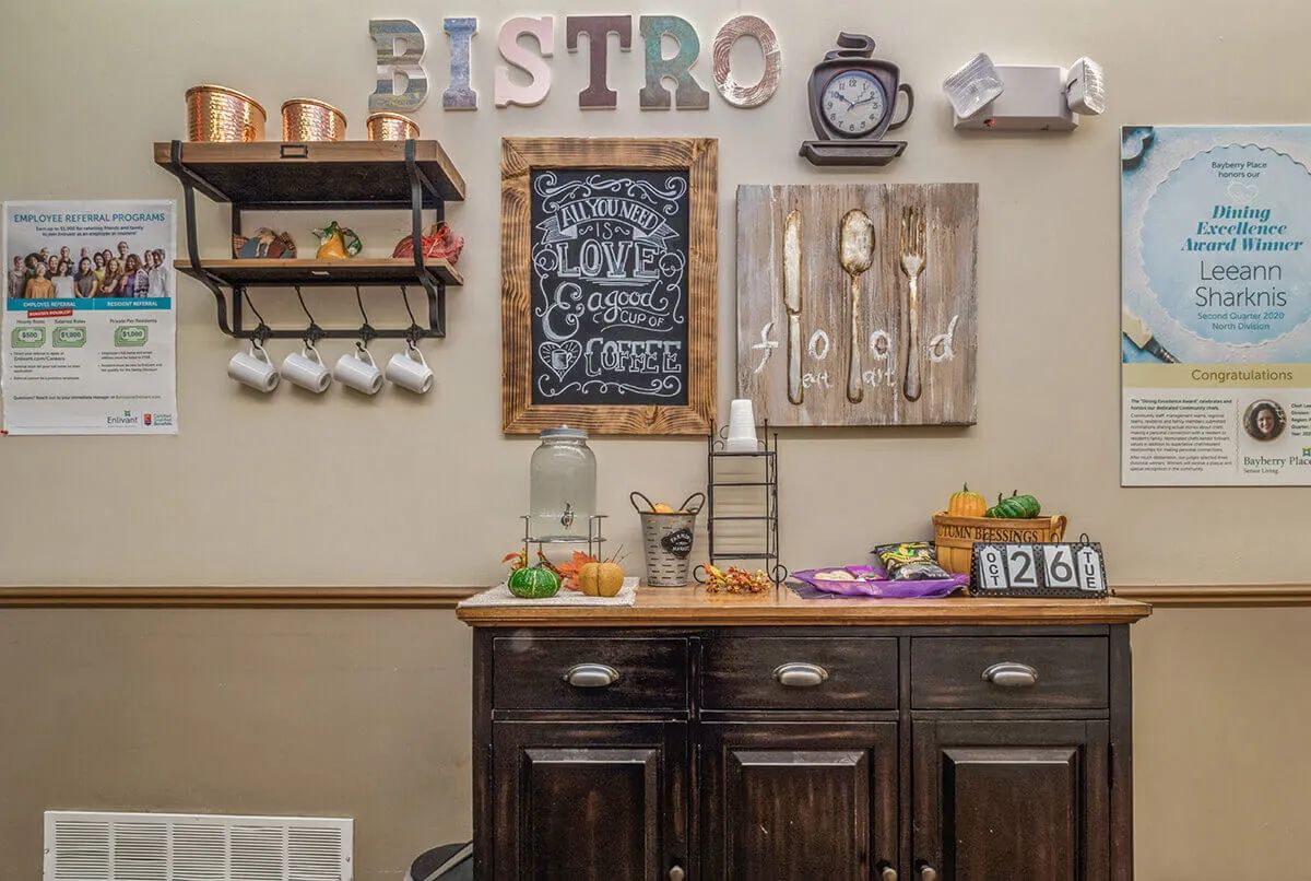 A cozy bistro-style kitchen corner with rustic decor and a coffee station.