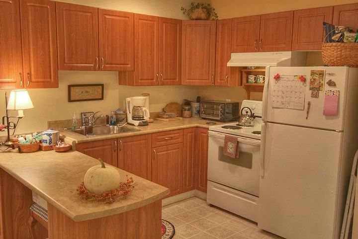 A cozy kitchen with wooden cabinets and modern appliances.