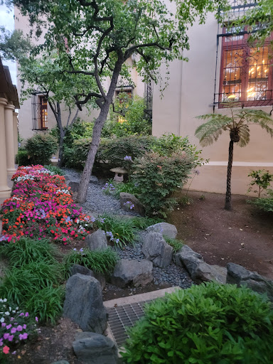 A serene garden path adorned with colorful flowers and lush greenery.