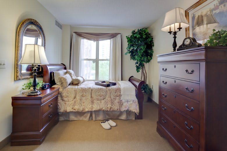 A cozy bedroom with traditional furniture and elegant decor.