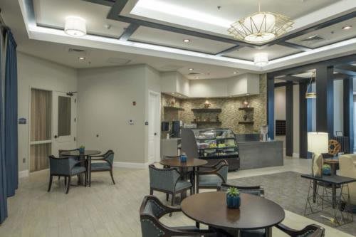 A modern cafe interior with seating area and counter.