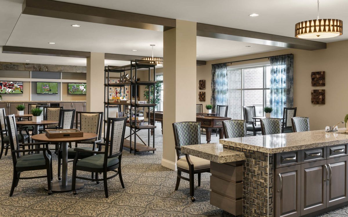 A modern dining and seating area with tables and chairs, featuring a stylish and open layout.