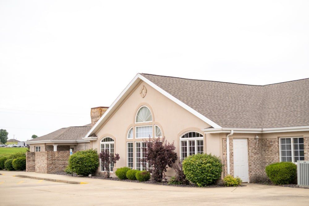 A suburban residential house with a sloped roof and large windows.