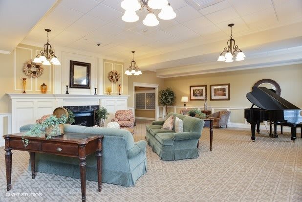 Elegant living room with cozy seating and a grand piano.