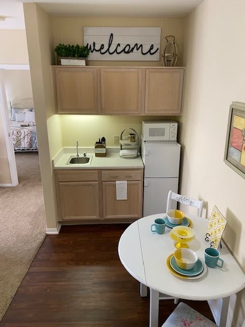 A cozy apartment kitchen with a small dining area, featuring modern decor and a welcoming atmosphere.