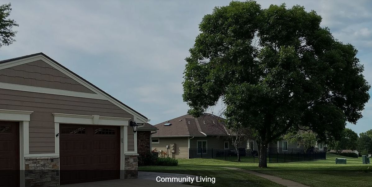 A peaceful suburban neighborhood with homes and lush green trees.