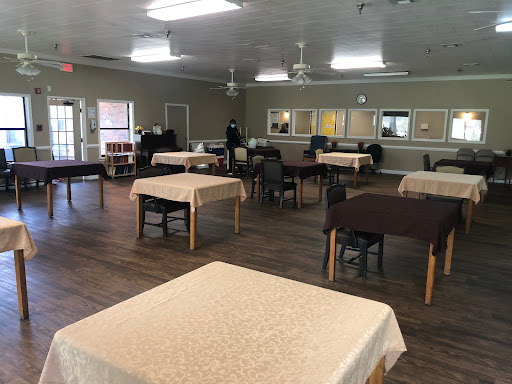 A spacious dining area set up with tables and chairs, ready for an event.