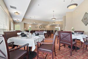 An elegant dining area with neatly arranged tables and chairs.